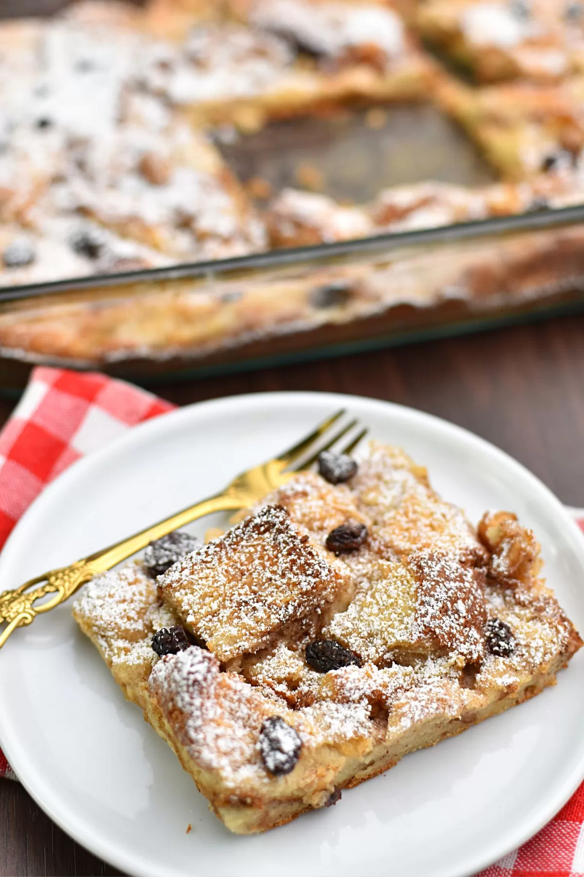 Cinnamon Raisin Bread Pudding on a white plate.